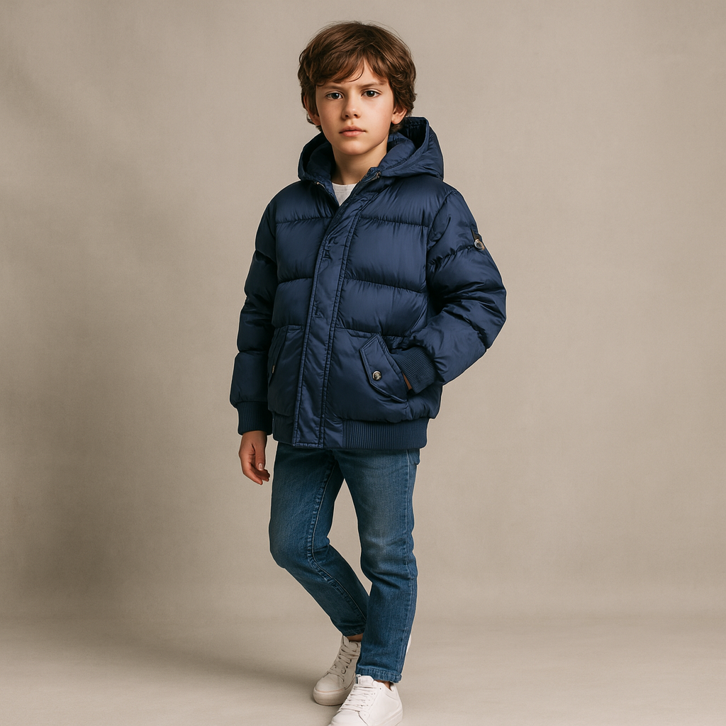 Child wearing a blue puffer jacket on a beige background