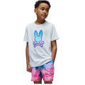 Child wearing a white t-shirt with a colorful graphic and tie-dye shorts on a white background