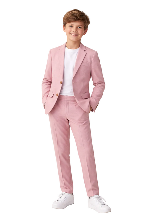 Young boy wearing a pink suit with a white shirt on a light background