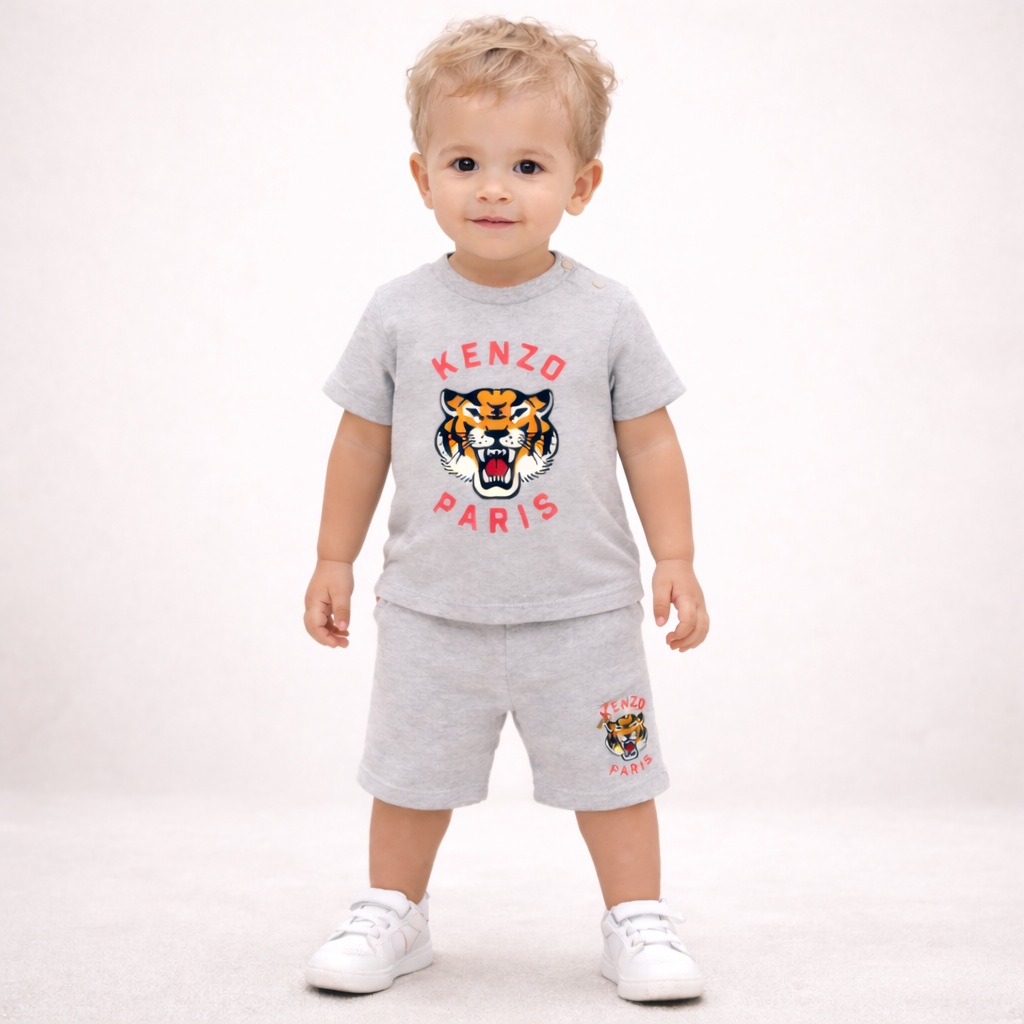 Child wearing a gray Kenzo Paris outfit with a tiger logo on a white background