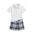 White polo shirt and blue plaid shorts set on a white background